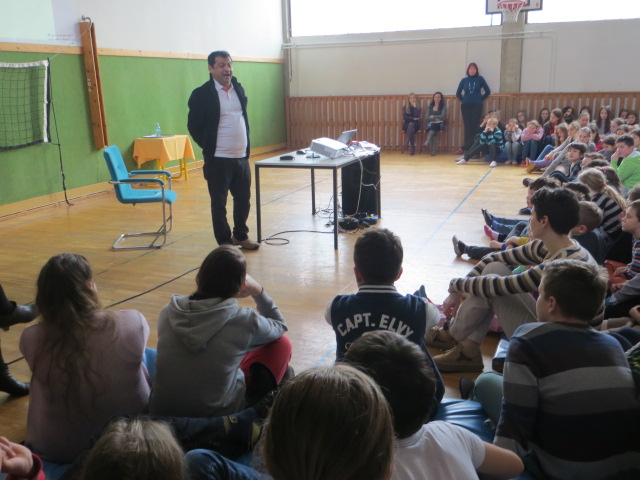 Deepak Thimaya speaking to students in a school hall