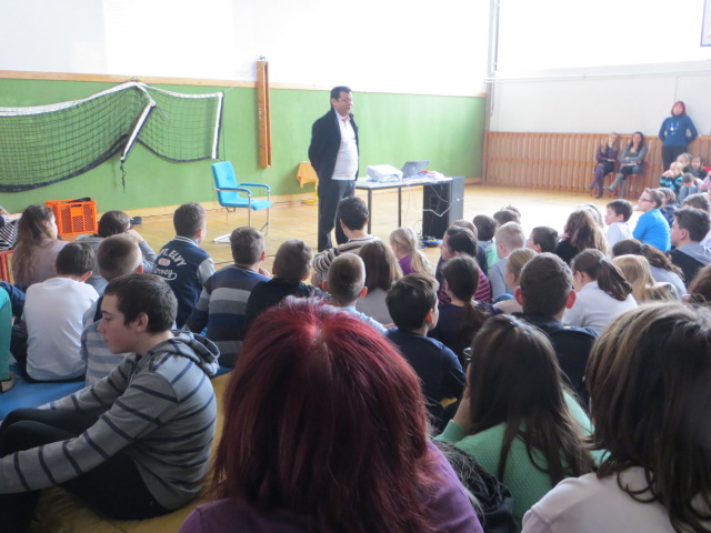 Students listening to Deepak Thimaya in a school hall