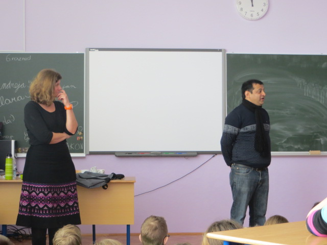 Deepak Thimaya speaking with a teacher and students